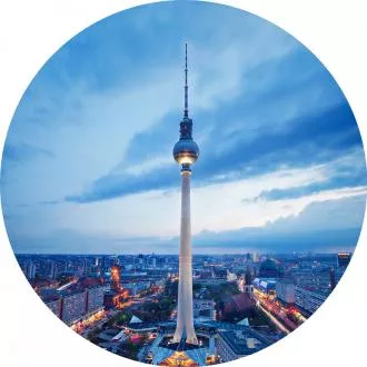 Berlin TV Tower at dusk with a cityscape view.